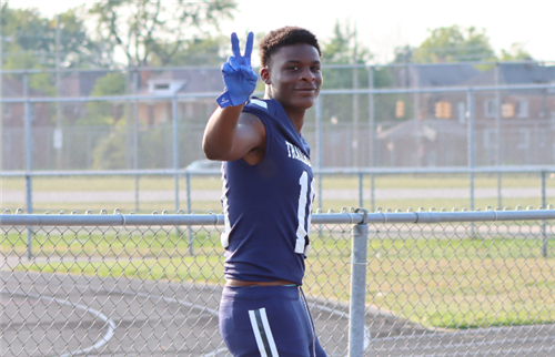 Young man in a football uniform smiling